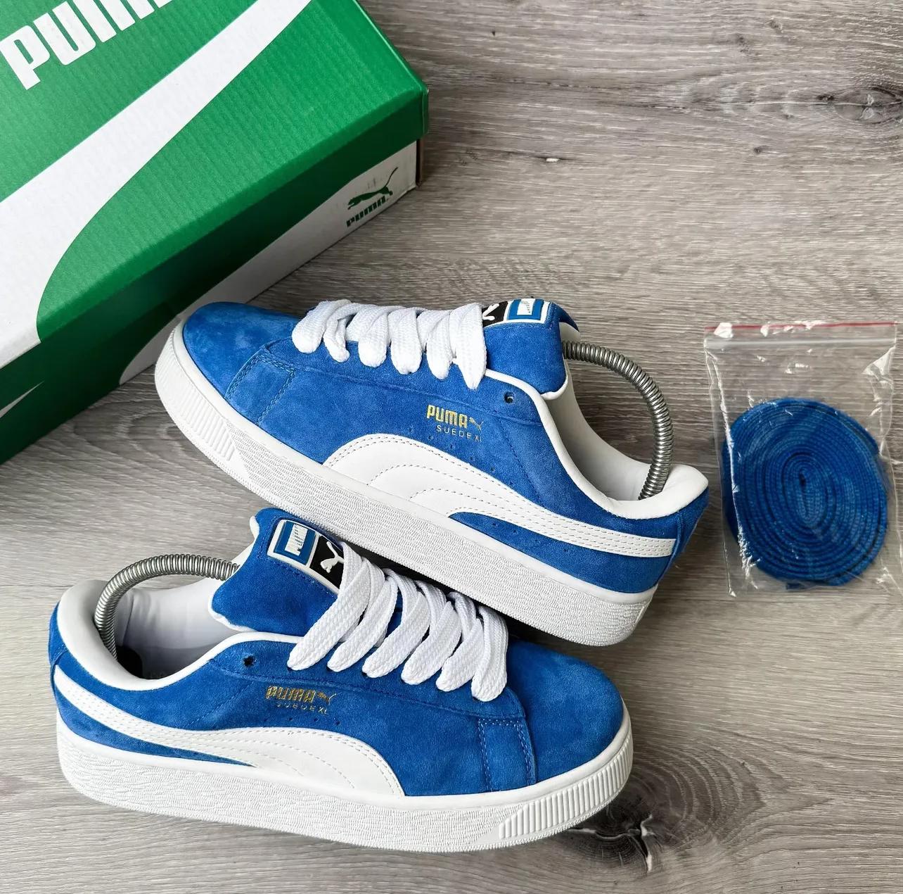 Blue and white  Puma sneaker with a sleek low-top design, featuring the signature Puma side stripe and cushioned sole for comfort and style.
